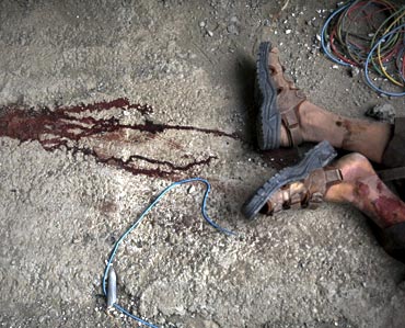A dead Taliban insurgent is seen after he was killed inside a building which militants took over near the US embassy in Kabul