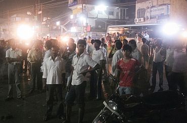 Residents stand together outdoors after an earthquake tremor in Patna