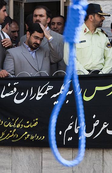 Tehran Prosecutor General Saeed Mortazavi adjusts his hair as he attends an execution by hanging in Tehran