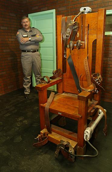 Aaron Dickson, President of the Board of Directors of the Texas Prison Museum stands Old Sparky, the Texas electric chair in which 361 killers were executed. The electric chair is in an exhibit called Riding the Thunderbolt in the non-profit Texas Prison Museum's new facility in Huntsville, Texas
