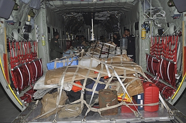 Soldiers load relief material for earthquake victims onto a plane at the Hindon air force station on the outskirts of New Delhi