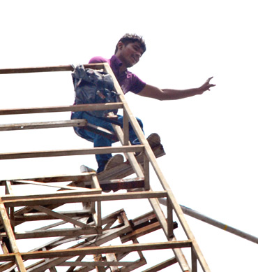 Srinivas atop a 100-metre high hoarding in Hyderabad