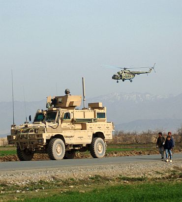 US soldiers provide security for Afghan National Security Forces' Mi-17 Hip helicopters preparing to land in Khanjarkhe, Afghanistan