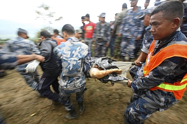 Armed police force transport bodies of the victims of Buddha Air plane crash in Lalitpur