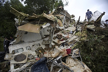 Nepalese police personnel are seen at the crash site of Buddha Air plane in Lalitpur
