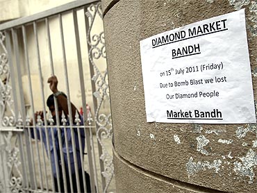 A private security guard stands next to a sign that reads 'Diamond market shut' at Opera House