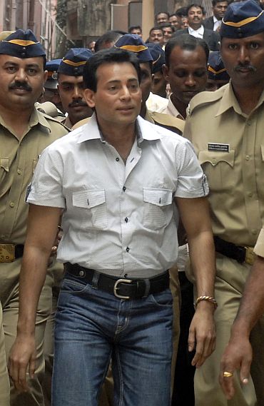 Salem is surrounded by policemen as he arrives at a court in Hyderabad