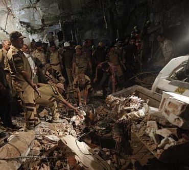 Rescue workers search for survivors under the rubble