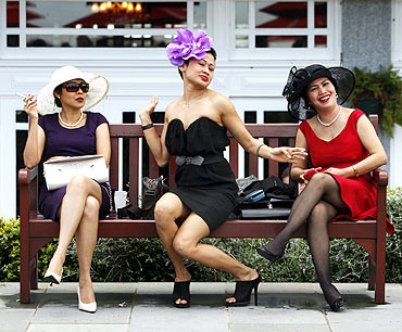 Race-goers strike a pose before the running of the Melbourne Cup