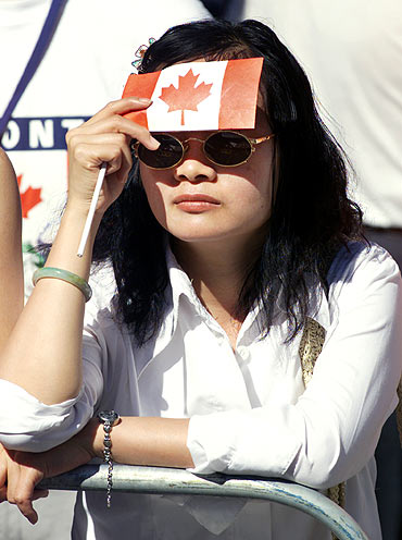 A Toronto woman shields her face from the sun