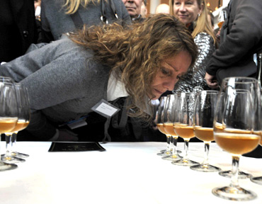 A woman smells samples of champagne in Mariehamn, Finland