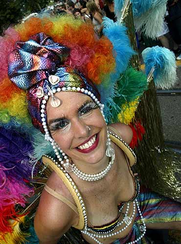 A dancer parades a colourful costume while dancing to the beat of music in downtown Zurich during the annual street parade