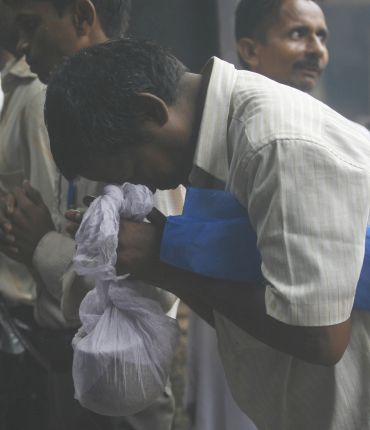 A relative of a Mumbai blasts victim prays at the crematorium