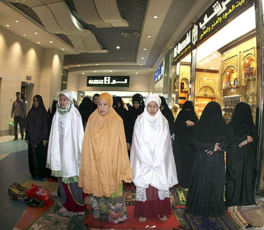 Women pray in a shopping centre at the Zamzam Tower next to the Grand Mosque in Mecca