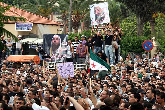 Protesters hold a poster of Osama bin Laden