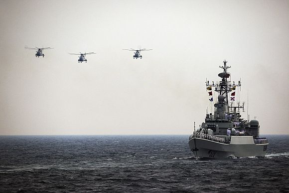 Helicopters accompany the Chinese Jiangwei II naval frigate