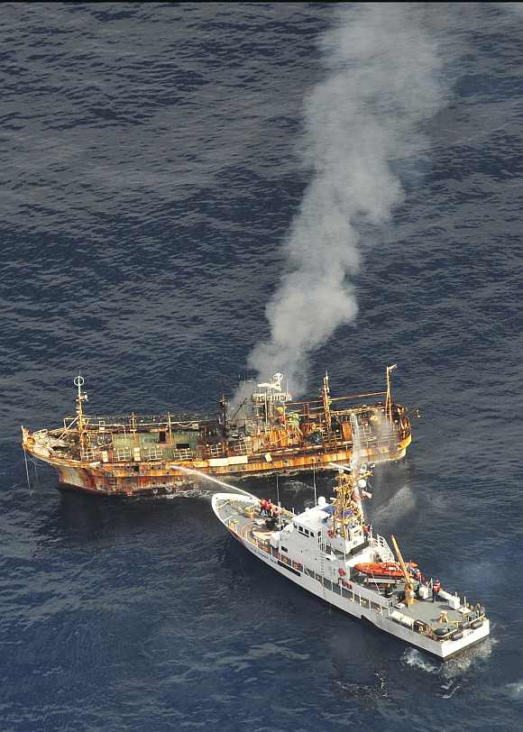 US Coast Guard Cutter Anacapa crew douses the adrift Japanese vessel with water after a gunnery exercise