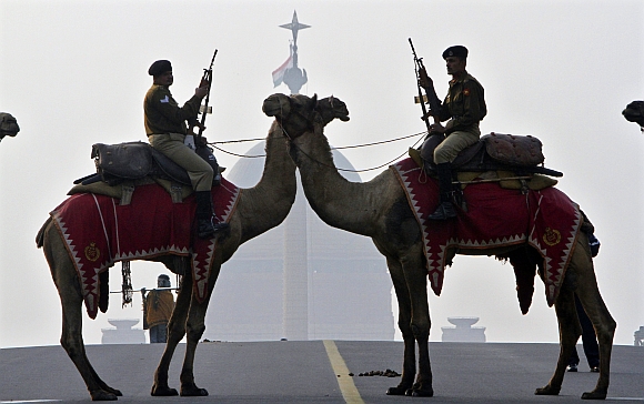 Border Security Force soldiers ride their camels in front of India's presidential palace Rashtrapati Bhavan during a rehearsal for the