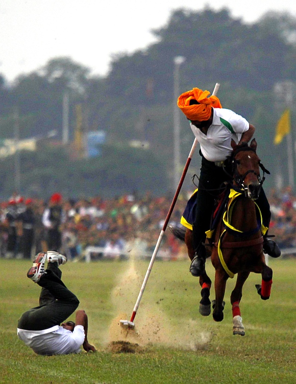 Army soldiers perform an equestrian stunt ahead of the Vijay Diwas celebrations in Kolkata