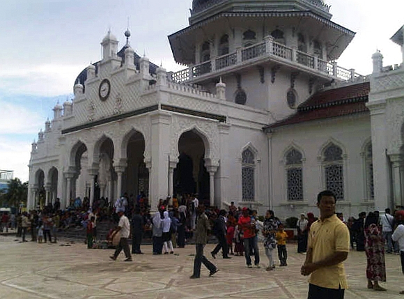 People gather outside the Baiturrahman mosque after an earthquake hit Banda Aceh in Indonesia