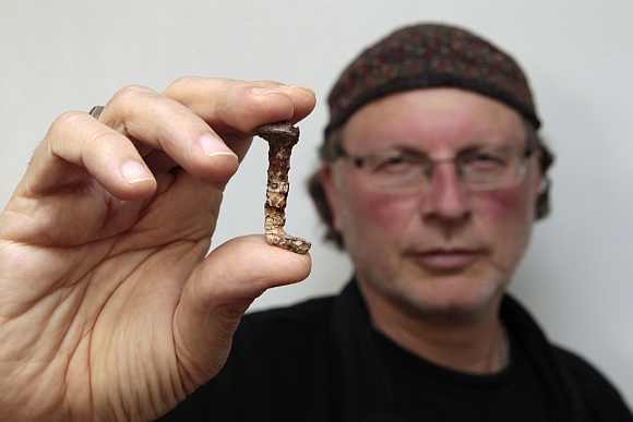 Veteran investigator Simcha Jacobovici holds one of the two nails presented in his new documentary film as having a connection to Jesus at Tel Aviv University on April 6. The film