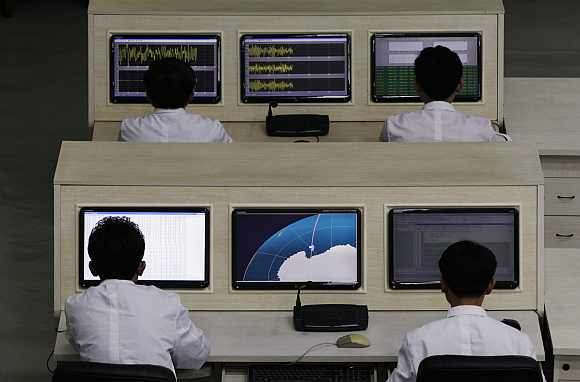 North Korean scientists work at the West Sea Satellite Launch Site, at the satellite control centre of the Korean Committee of Space Technology on the outskirts of Pyongyang