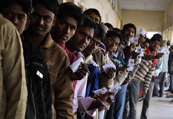 Voters at a polling station during the second phase of UP elections, in Gorakhpur