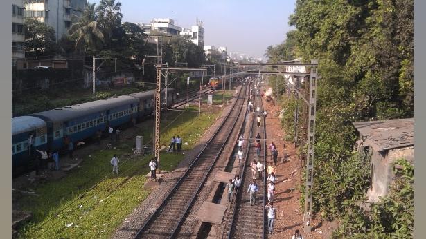 Commuters had to walk on the tracks due to delayed svcs. File pic