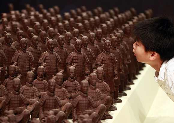 A boy looks at chocolate Terracotta Warriors displayed at the World Chocolate Wonderland in Taipei