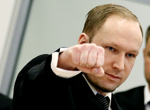 Defendant Anders Behring Breivik gestures as he arrives at the start of the third day of proceedings in courthouse in Oslo