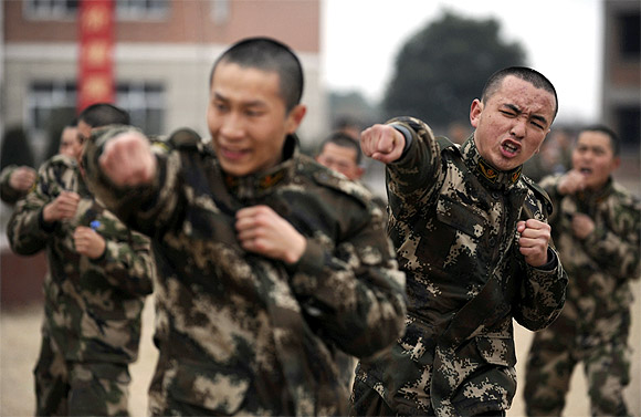 Recruits from the People's Liberation Army attend a training session at a military base in Jiaxing, Zhejiang province
