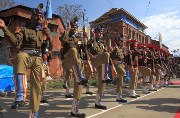 Police and CRPF personnel present the guard of honour at the bunker dismantling site at Lal Chowk