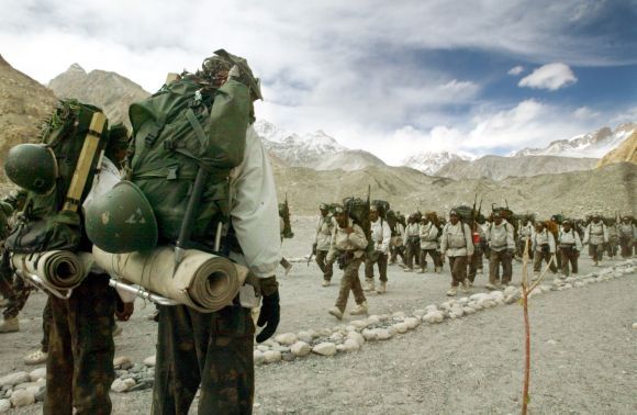 Indian soldiers muster at the base camp after coming back from training at Siachen Glacier