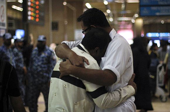Family members of the passengers of the Bhoja Air airliner crash console one another at Jinnah International airport in Karachi