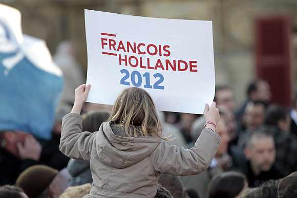 A supporter for Francois Hollande attends a campaign rally in Charleville-Mezieres