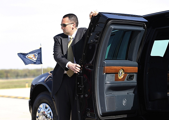 A US Secret Service Agent holds the limousine door of US President Barack Obama