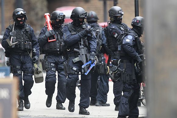 Armed police officers walk in Tottenham Court Road in central London on Friday during a hostage crisis