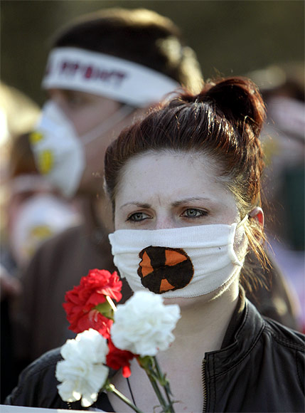 Activists wearing masks with a radioactive danger sign attend an opposition protest to mark the Chernobyl nuclear accident in Minsk