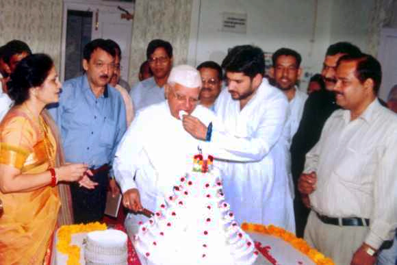 Rohit Shekhar feeds ND Tiwari a piece of cake on the latter's birthday.