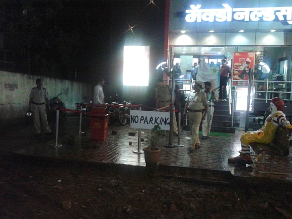 A policeman inspects the site of an explosion near McDonalds restaurant in Pune