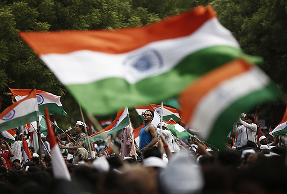 Supporters of Hazare wave flags in New Delhi