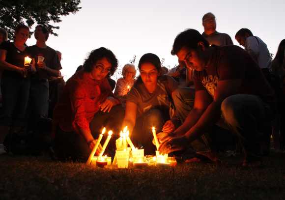 People light candles during a vigil at Cathedral Square to honor victims of Oak Creek in downtown Milwaukee after the gurudwara shooting