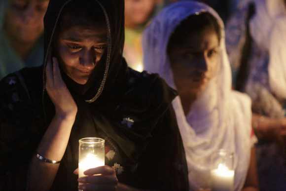 Mourners cry during a candlelight vigil at the Sikh Temple in Brookfield, Wisconsin August 6