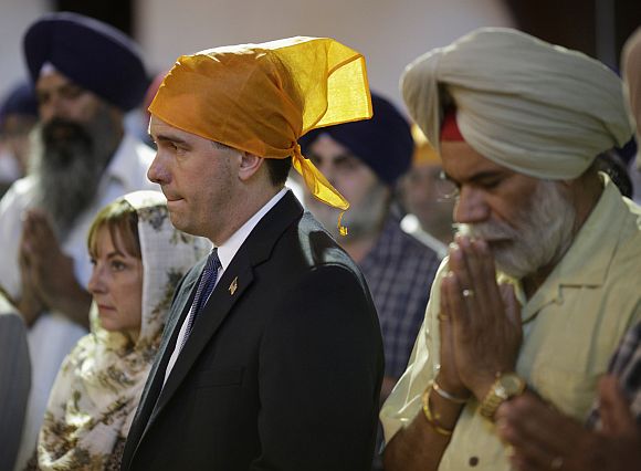 Wisconsin Governor Scott Walker attends a prayer service at the Sikh Temple in Brookfield, Wisconsin