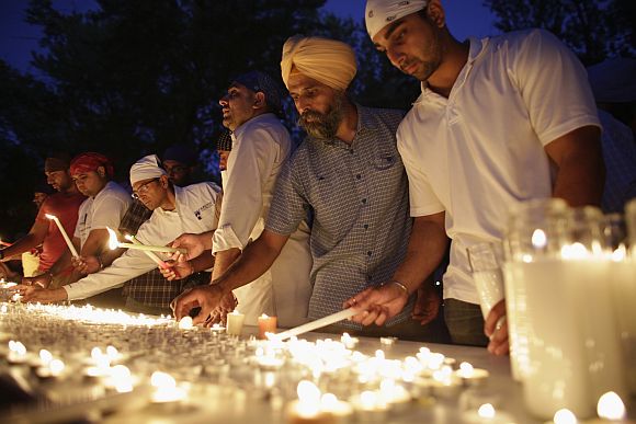 Mourners prepare for a candlelight vigil at the Sikh Temple in Brookfield, Wisconsin
