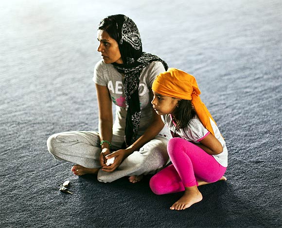 Raj Kaur (Left) and her four-year-old daughter Sahaj Kaur pray at the Gurdwara Sahib Sikh Temple in West Sacramento, California