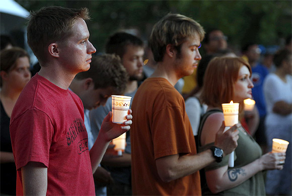 People gather at a candle light vigil at Cathedral Square in downtown Milwaukee, Wisconsin