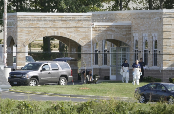 FBI agents walk past the entrance to the Sikh Temple in Oak Creek, Wisconsin