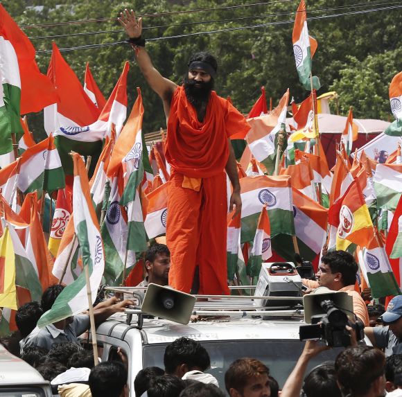 Ramdev waves to his supporters during a protest march against corruption in New Delhi