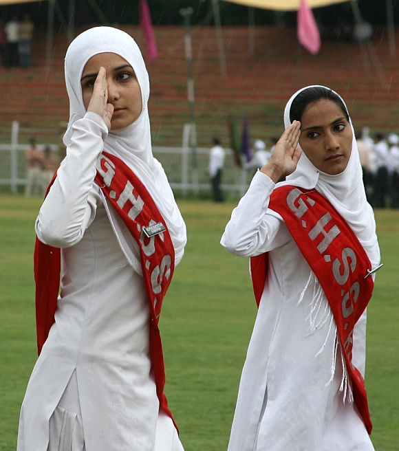 College girls salute during a parade after unfurling of the Tricolour